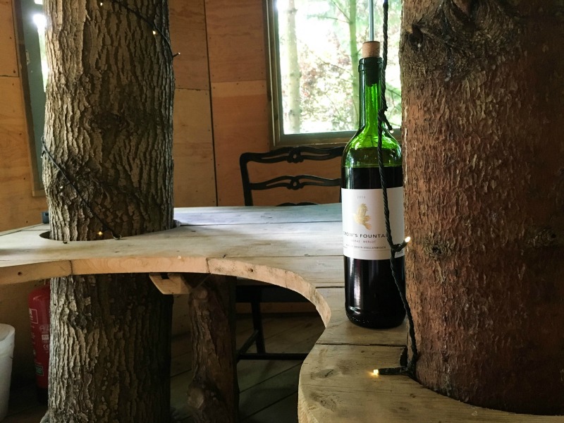 A giant table stands at the centre of the treehouse living area, complete with trees growing through its curved edges - the perfect social centrepiece.