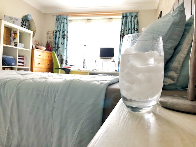 Putting iced water by your bed helps to cool the air close to your head and help you sleep in the heat